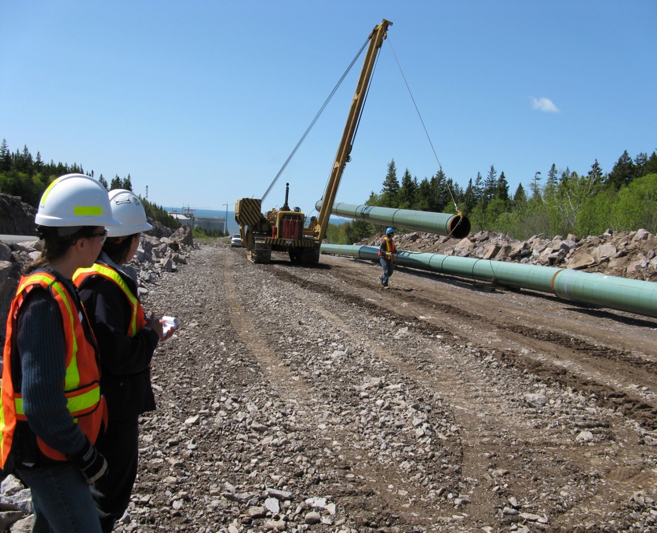Inspection officers oversee pipeline construction.